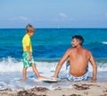 Boy with father surfing