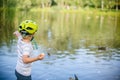 Boy feeding ducks and pigeons in the park by the lake Royalty Free Stock Photo