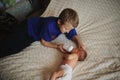 Boy feeding newborn baby with bottle of milk Royalty Free Stock Photo