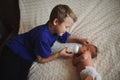 Boy feeding newborn baby with bottle of milk Royalty Free Stock Photo