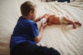 Boy feeding newborn baby with bottle of milk Royalty Free Stock Photo