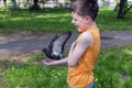 A boy feeds a pigeon from his hand