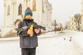 The boy feeds the pigeons on his hands, standing on the square Royalty Free Stock Photo