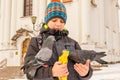 The boy feeds the pigeons on his hands, standing on the square Royalty Free Stock Photo