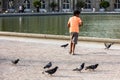 The boy feeds the pigeons in the Luxembourg Gardens. Paris, Fran Royalty Free Stock Photo