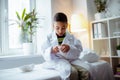 Boy feeling curious playing with model of brain in father office