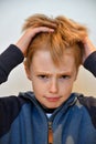 Boy feels misunderstood and pulls his hair Royalty Free Stock Photo