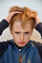 Boy feels misunderstood and pulls his hair Royalty Free Stock Photo