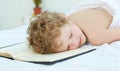 Boy fell asleep on the entries in the notebook. Healthy sleep concept