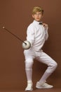 Boy fencer standing in attacking pose