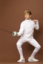 Boy fencer standing in attacking pose