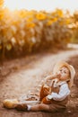 a boy in a field of sunflowers eats wheat bread Royalty Free Stock Photo