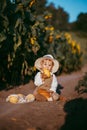 a boy in a field of sunflowers eats wheat bread Royalty Free Stock Photo