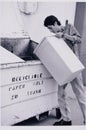 Boy fills recycle bin Royalty Free Stock Photo