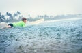 Boy first step surfer learning to surf under tropical rain Royalty Free Stock Photo