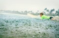 Boy first step surfer learning to surf under tropical rain Royalty Free Stock Photo