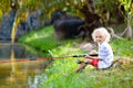 Boy fishing. Child with rod catching fish in river Royalty Free Stock Photo