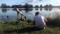 Boy fishing on a lake. Beautiful fish pond near Badin, Banska Bystrica, Slovakia. Fishing place.