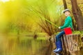 Boy fishing near beautiful pond with fishrod Royalty Free Stock Photo