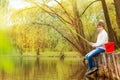 Boy fishing near the pond with green fishrod Royalty Free Stock Photo