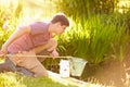 Boy Fishing In Pond With Net And Jar Royalty Free Stock Photo