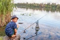 Boy with a fishing rod catches a fish Royalty Free Stock Photo