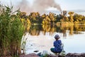 Boy with a fishing rod catches a fish Royalty Free Stock Photo