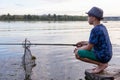 Boy with a fishing rod catches a fish Royalty Free Stock Photo