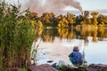 Boy with a fishing rod catches a fish Royalty Free Stock Photo