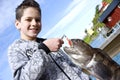 Boy and fishing trophy Royalty Free Stock Photo