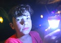 Boy with flashlight on night