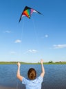 Boy flies kite into blue sky Royalty Free Stock Photo