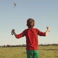 Boy flies kite into blue sky Royalty Free Stock Photo