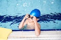Boy With Float Resting On Edge Of Swimming Pool During Lesson Royalty Free Stock Photo
