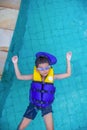 Boy floating / swimming with life vest and googles