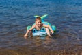 Boy floats on a rubber dolphin in the sea