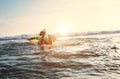 Boy floats on surf board. Beginner surfer, first lessons Royalty Free Stock Photo