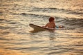 Boy floats on surf board. Beginner surfer, first lessons Royalty Free Stock Photo