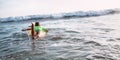 Boy floats on surf board towards the waves Royalty Free Stock Photo