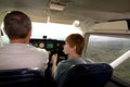 Boy is flying aircraft assisted by a trainer