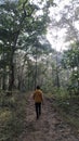 Boy in a forest. Wearing yello jachet