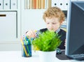 Boy in the form of an office worker plays with the dividers