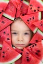 A boy framed by triangular pieces of watermelon.Cute portrait of a baby Royalty Free Stock Photo