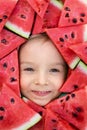 A boy framed by triangular pieces of watermelon.Cute portrait of a baby Royalty Free Stock Photo
