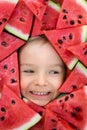 A boy framed by triangular pieces of watermelon.Cute portrait of a baby Royalty Free Stock Photo