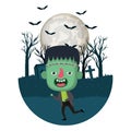 Boy with frankenstein costume in dark cemetery and bats flying Royalty Free Stock Photo