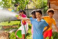 Boy and friends in water gun fight active fun game Royalty Free Stock Photo