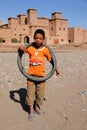 Boy in front of Kasbah in Skoura Royalty Free Stock Photo