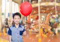 Boy in front of merry go round Royalty Free Stock Photo