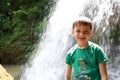 Boy in front of waterfall Shum on rufabgo stream Royalty Free Stock Photo
